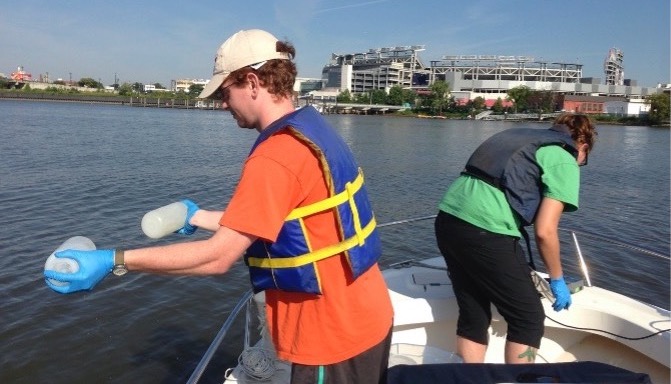 A picture of Dr. Caroline Solomon on a boat collecting water samples