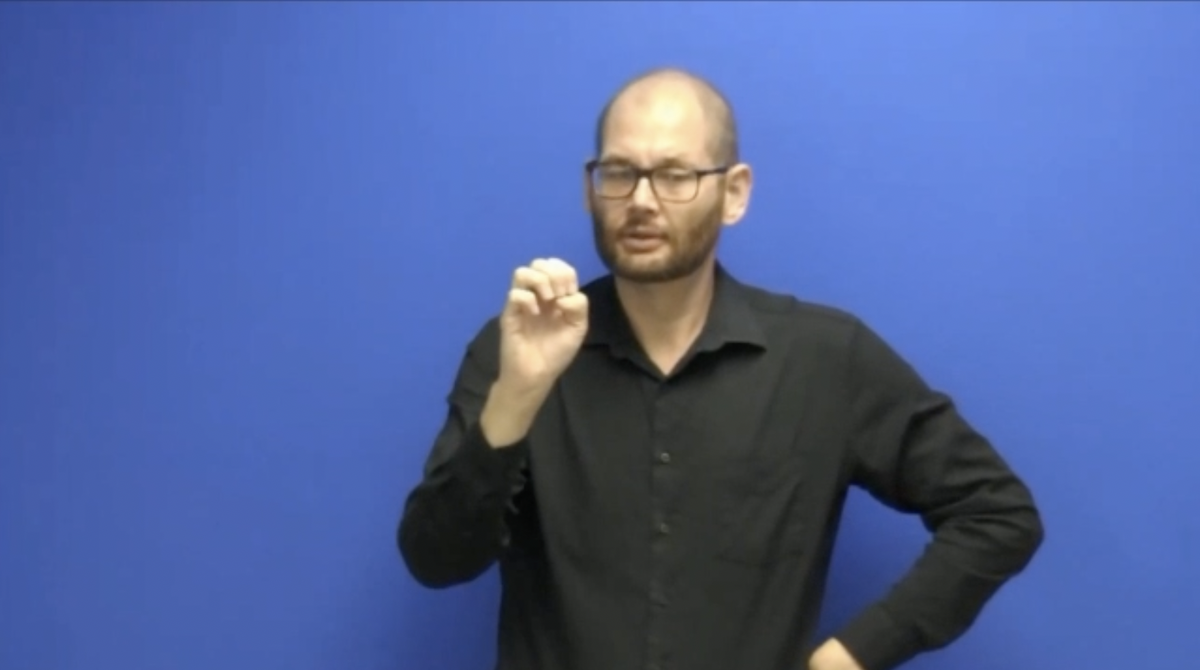 Screenshot of a man signing from the video of an example of interpretations of life science terms.